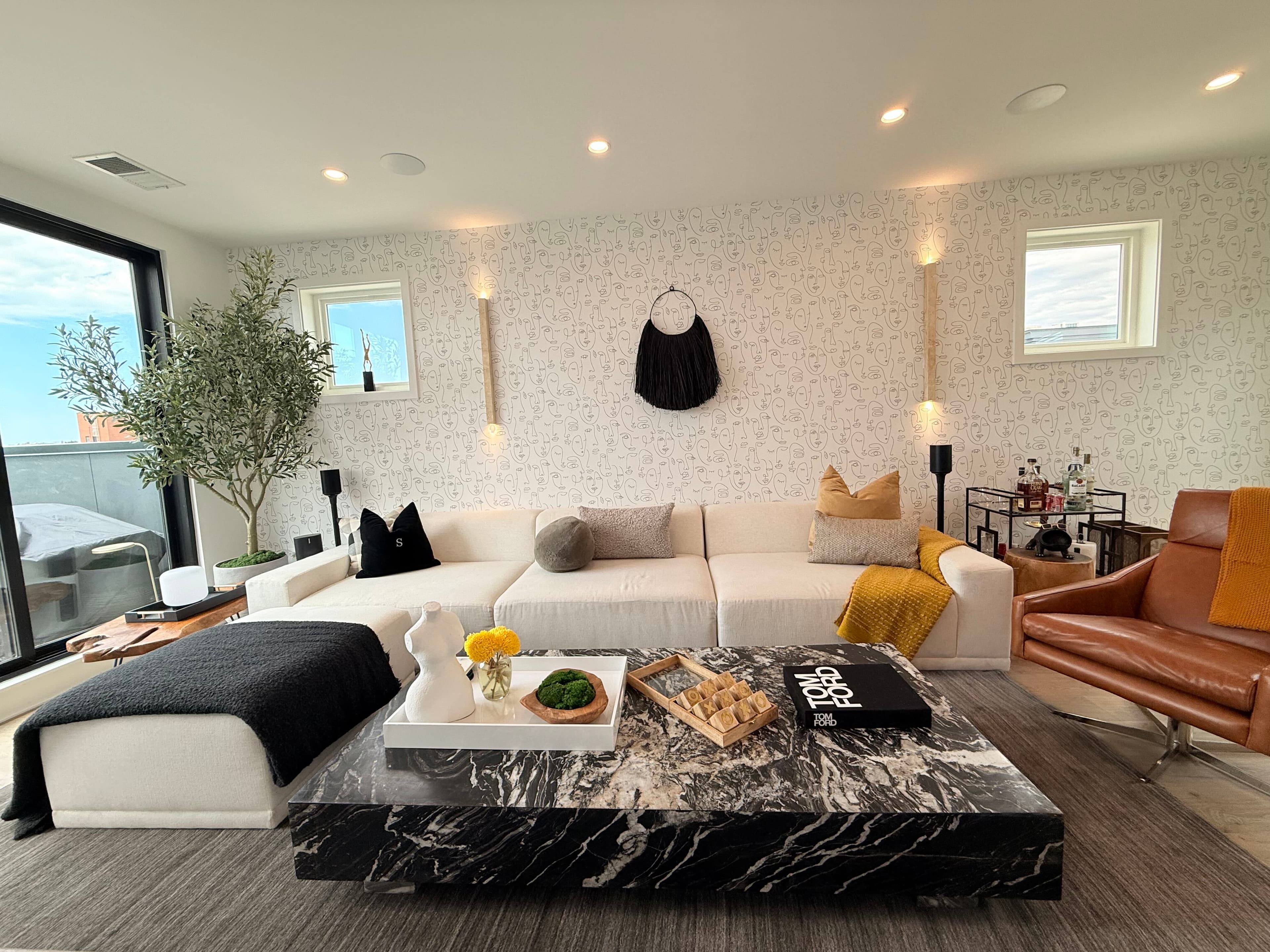 The refined loft interior with black marble table and patterned wall at Pond & Perch.